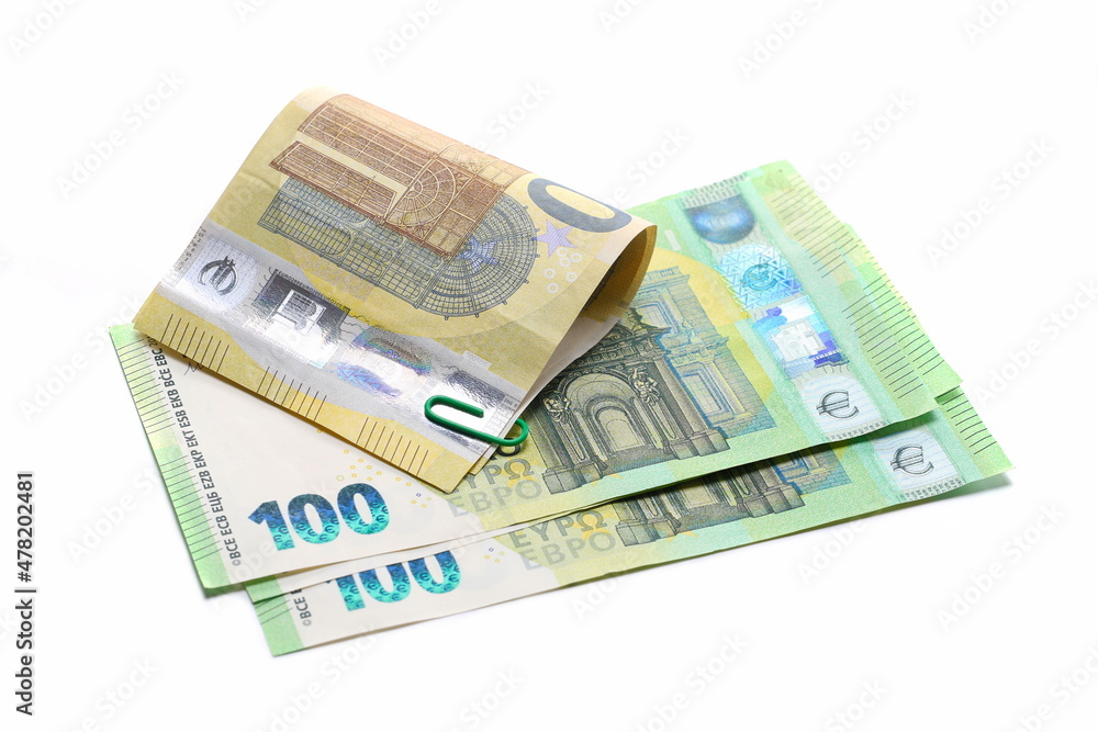 Two hundred euro banknotes, cash paper money and paper clips isolated on white Two hundred euro banknotes, cash paper money and paper clips isolated on white
