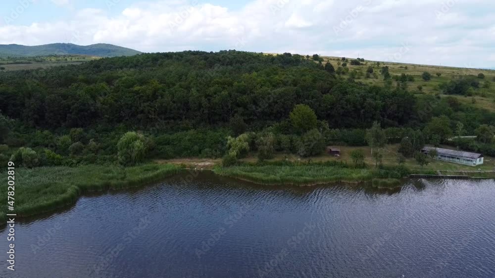 Reeds at Rakaca Reservoir. Lake and Trees. Shore and mountains in the background. Szalonna. Drone Video. Hungary. Europe Reeds at Rakaca Reservoir. Lake and Trees. Shore and mountains in the background. Szalonna. Drone Video. Hungary. Europe