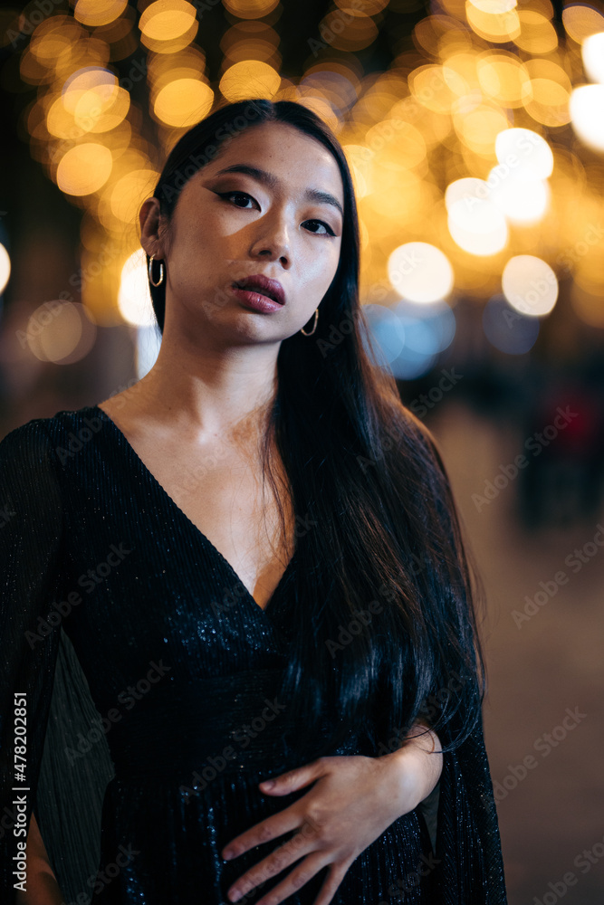 Fashion portrait of Young Asian woman on the street at night