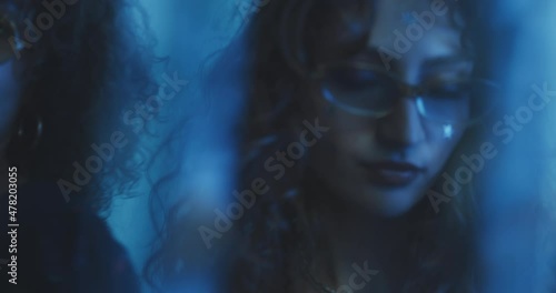 Curly girls dancing through a glitter curtain. photo