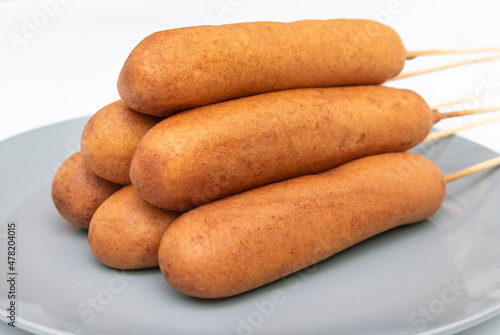 Salchicas fritas y empanizadas con pasta de hot cakes.