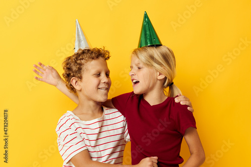 Small children holiday fun with caps on your head yellow background