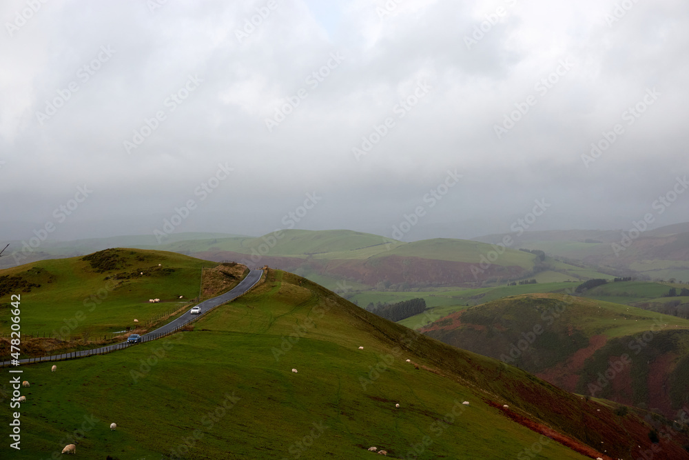 Beautiful day in Welsh mountains with a twisty road. United Kingdom, Wales in late winter.