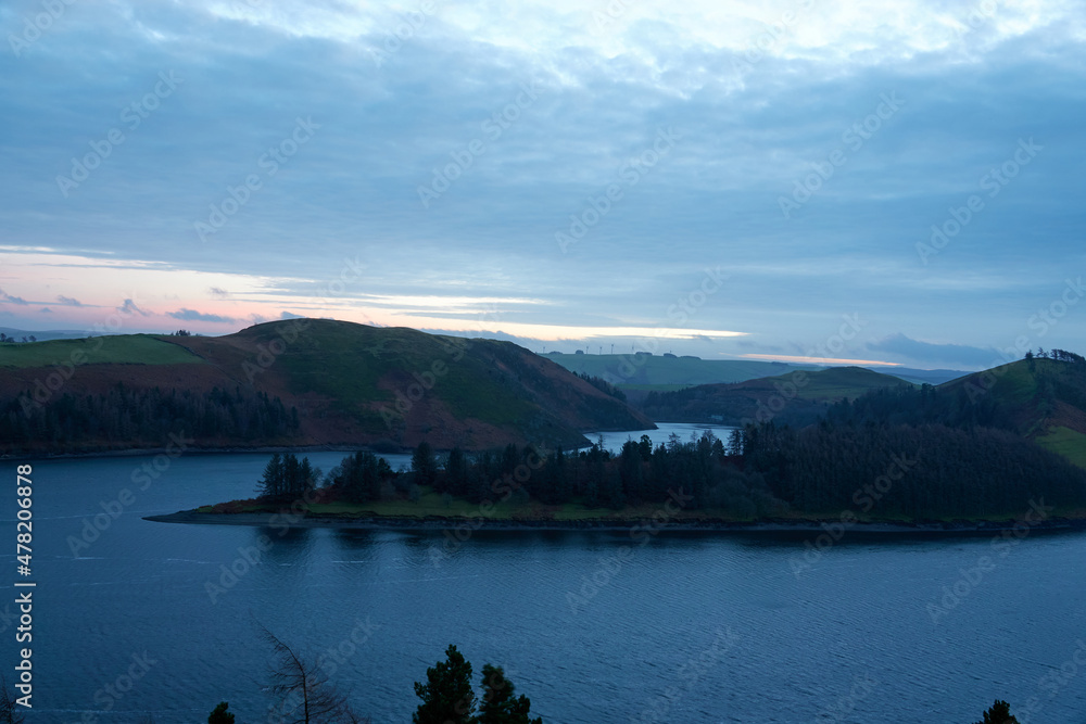 Lake in the evening. Sunset. Clouds. United Kingdom, Wales in late winter.