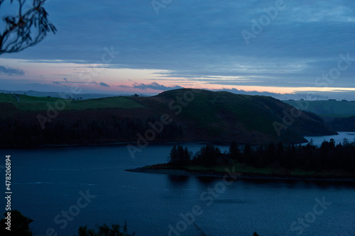Lake in the evening. Sunset. Clouds. United Kingdom  Wales in late winter.