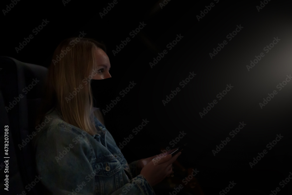 Woman turns off the phone before watching a movie in the cinema. Woman turns off the phone before watching a movie in the cinema.