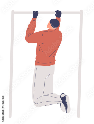 Man training outdoors in winter, pulling up on bar