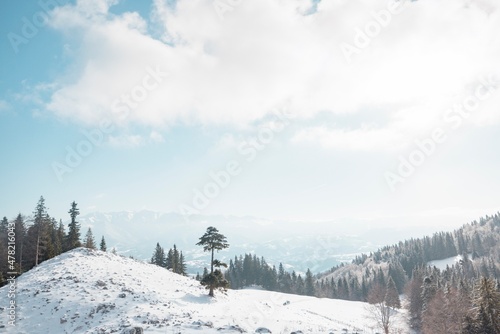 People hiking in beautiful winter mountains for winter sport activity snow mountain hills. Going for hikes in the winter for winter sports like winter hiking and cross-country skiing is very rewarding