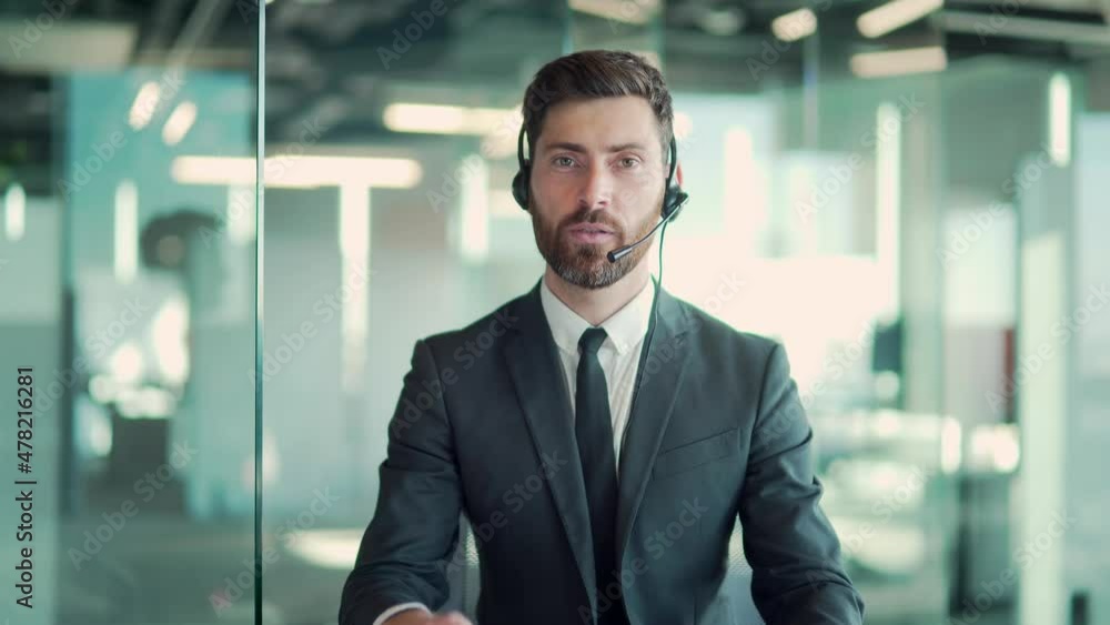 Caucasian business man speaker in suit with headset talking looking at camera. Online meeting, conference, distance learning, remotely training via video call in a modern office class. Webcam view Caucasian business man speaker in suit with headset talking looking at camera. Online meeting, conference, distance learning, remotely training via video call in a modern office class. Webcam view