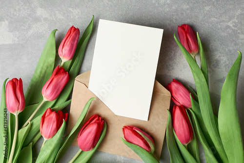 Photography Greeting card mockup with red tulips and envelope on grey concrete background