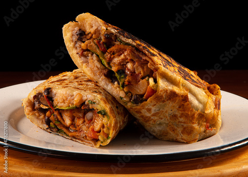 Burrito with meat on a white plate photo