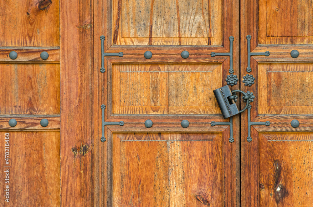 Old wooden door with beautiful iron details and an ancient padlock, in a house in Changdeokgung Palace, Seoul, South Korea Old wooden door with beautiful iron details and an ancient padlock, in a house in Changdeokgung Palace, Seoul, South Korea