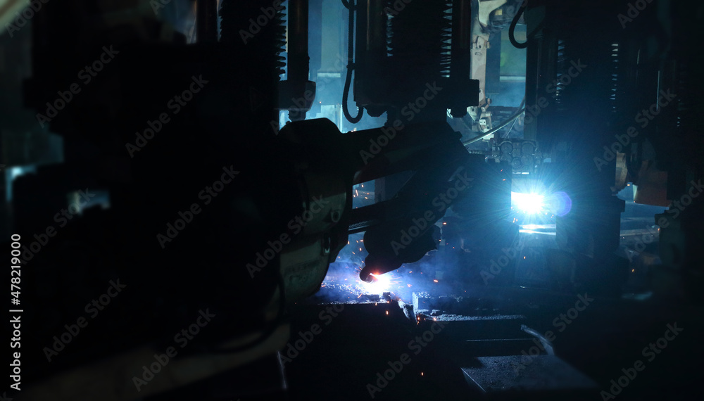 welding robot in the automotive parts industry, The movement of the robot welding in auto parts factory. welding robot in the automotive parts industry, The movement of the robot welding in auto parts factory.