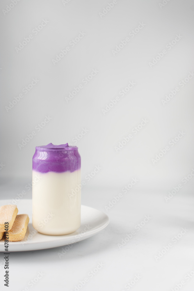 Ube whipped cream and milk, ube latte, purple latte, violet whipped cream, purple potato latte with savoiardi cookies Ube whipped cream and milk, ube latte, purple latte, violet whipped cream, purple potato latte with savoiardi cookies