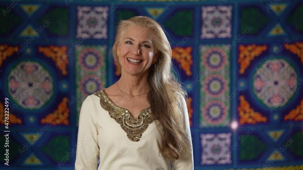 Pretty blonde woman smiling looking directly at camera set against a Middle Eastern background. Pretty blonde woman smiling looking directly at camera set against a Middle Eastern background.
