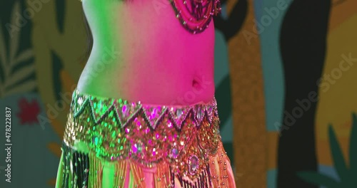 Tight shot of woman belly dancing