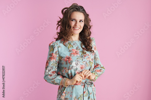 smiling elegant woman with long wavy brunette hair on pink