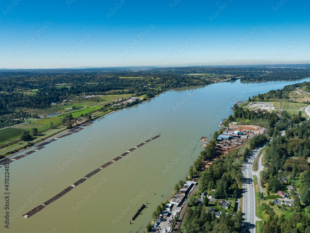 Stock Aerial Photo of Tug Boats Pulling Long Section of Log Booms on the Fraser River, Canada