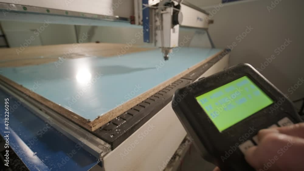 CNC cutting machine at work, cutting acrylic plastic sheets. Production of advertising signs CNC cutting machine at work, cutting acrylic plastic sheets. Production of advertising signs