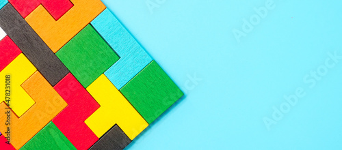 colorful wood puzzle pieces on blue background, geometric shape block. Concepts of logical thinking, Conundrum, solutions, rational, strategy, world logic day and Education
