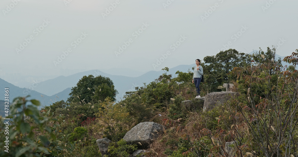 Woman enjoy the scenery view on the top of mountain