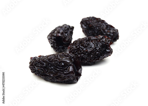 Black dried jujube on white background.