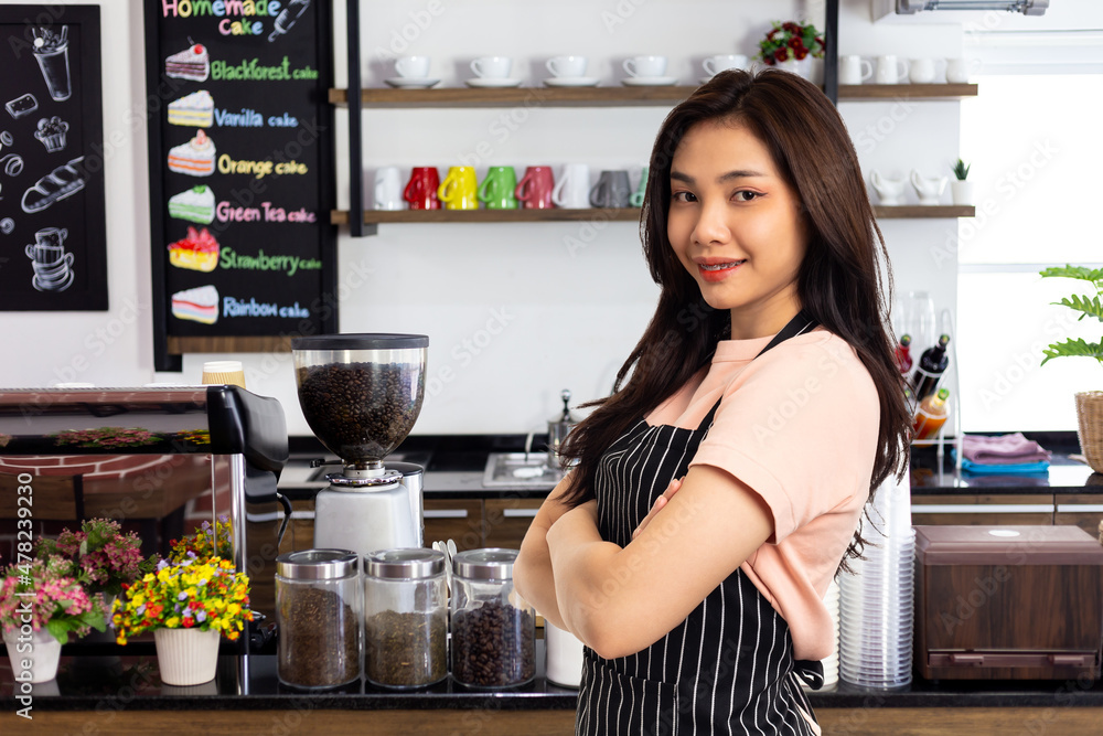 Portrait of confident and woman barista standing behind counter. female confidently starting a new business Portrait of confident and woman barista standing behind counter. female confidently starting a new business