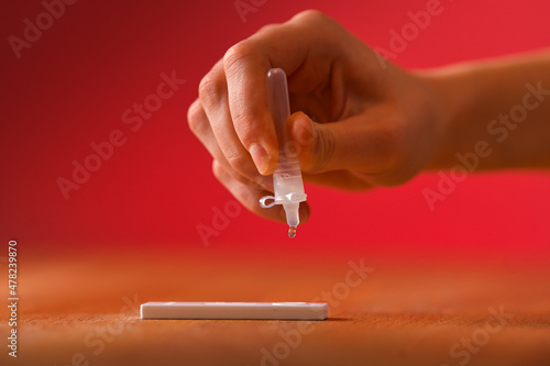 COVID-19 pandemic. Concept photo of a woman hand making the speed antigen test to confirm coronavirus infection.