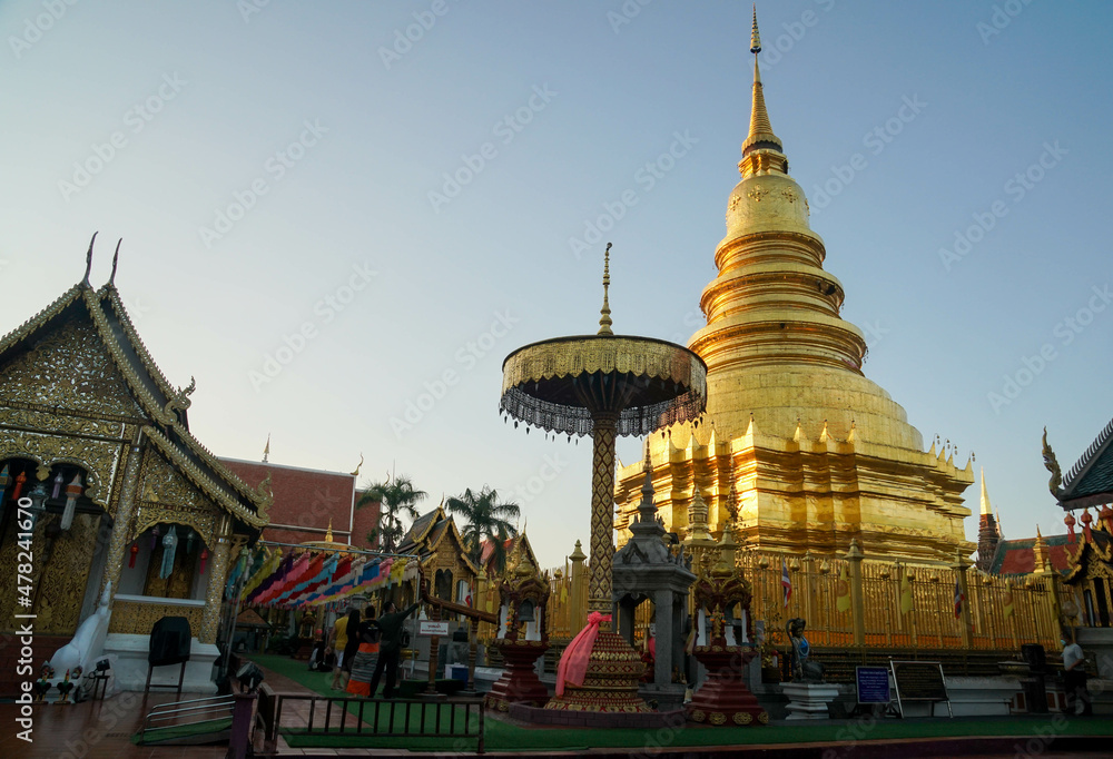 Fototapeta premium Thailand - November 29 2021: golden Haripunchai Pagoda in temple, the famous destination and tourist attraction in the North of Thailand