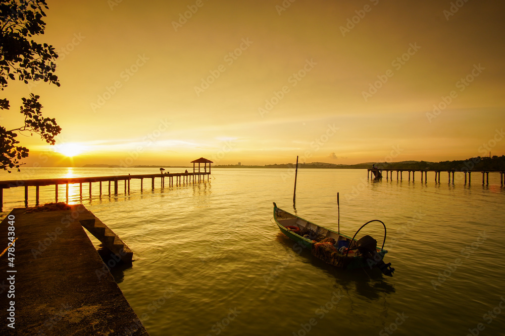 Fototapeta premium Sunset scenic view at seascape with long pier background 