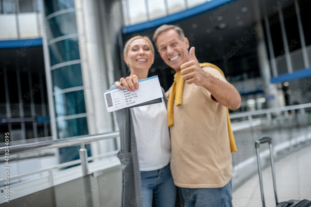 Happy airline passengers posing for the camera Happy airline passengers posing for the camera