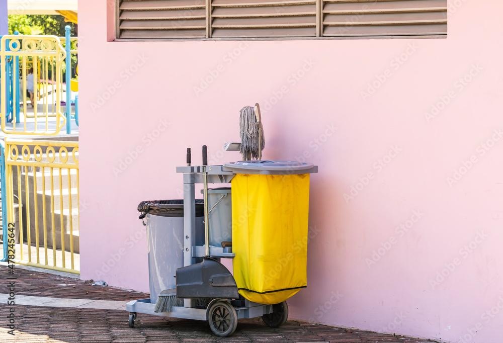 Cleaner cart in a public place with pink background Cleaner cart in a public place with pink background