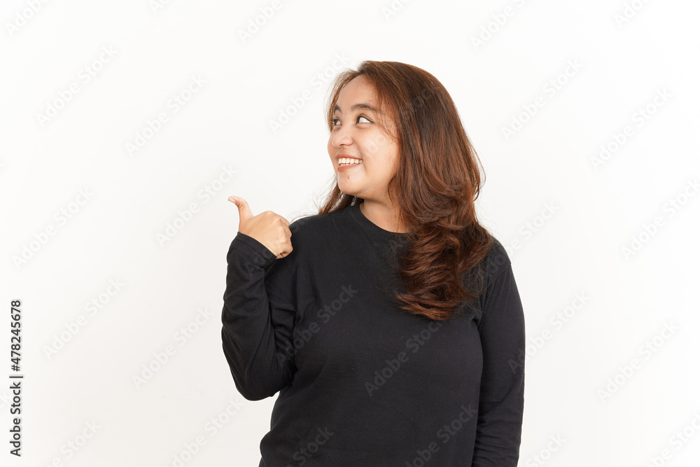 Showing and Pointing Aside with Thumb Of Beautiful Asian Woman Wearing Black Shirt Showing and Pointing Aside with Thumb Of Beautiful Asian Woman Wearing Black Shirt