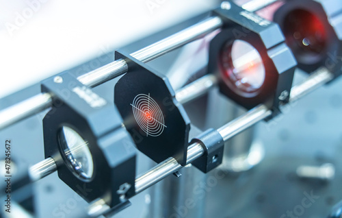 Experiment with laser device in optical laboratory photo