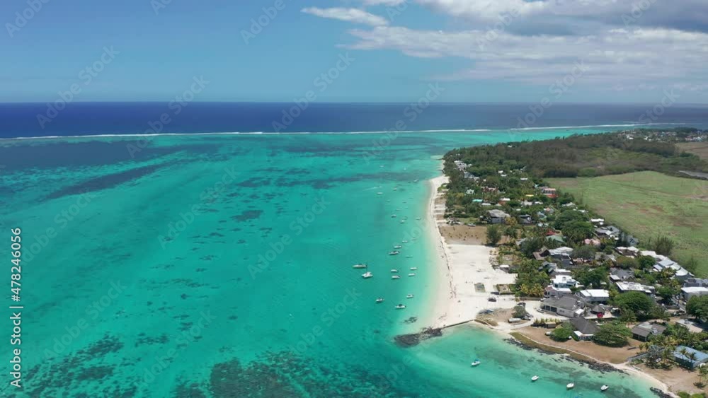 Aerial view of the ocean in Mauritius. Turquoise water with sandbanks, reef and an island. Flying around a wakeboarding Boat Aerial view of the ocean in Mauritius. Turquoise water with sandbanks, reef and an island. Flying around a wakeboarding Boat