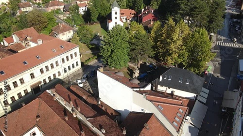 Downtown Ivanjica, Serbia. Aerial View of Central Buildings and Orthodox Church on Sunny Summer Day. Revealing Drone Shot photo