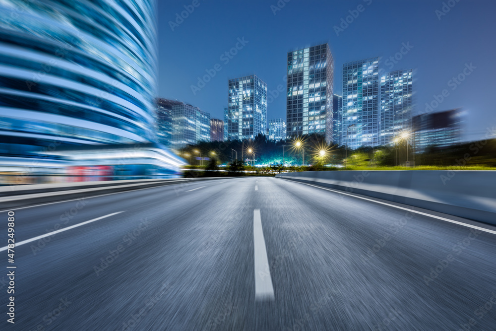 Naklejka premium Motion blurred asphalt road and modern commercial building landscape in Beijing, China.