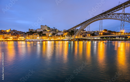 The old town of Porto with the river Douro and the famous iron bridge at dusk © elxeneize