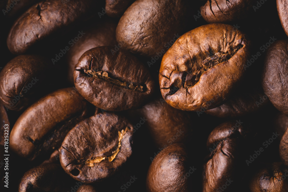 Roasted coffee beans full frame background Close up macro dark brown Roasted coffee beans full frame background Close up macro dark brown