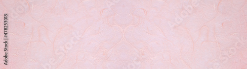 Valokuva 桃色の手漉き和紙の表面のテクスチャー。横に長いパノラマの背景素材。