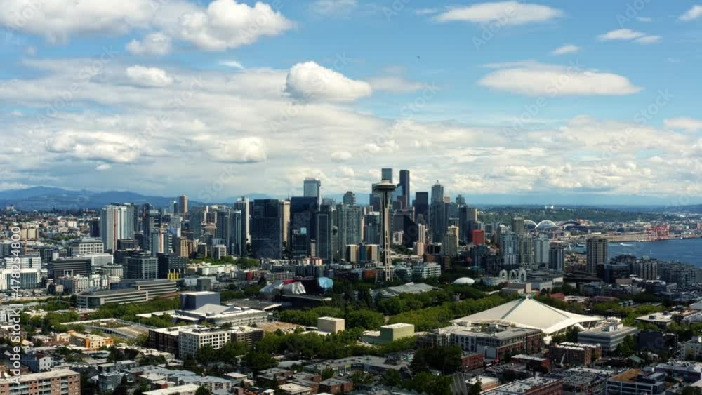 Beautiful aerial rising drone shot of the stunning Seattle skyline from Kerry Park with a view of the observation tower and the bay on a sunny summer day in Washington. Beautiful aerial rising drone shot of the stunning Seattle skyline from Kerry Park with a view of the observation tower and the bay on a sunny summer day in Washington.