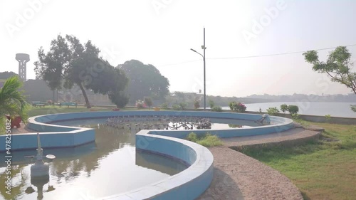 Dolly Around Enclosed Pond Beside Keenjhar Lake On Bright Sunny Day photo