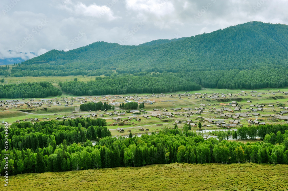Mountains and forests surround the natural scenery of Hemu village in Kanas, Xinjiang, China