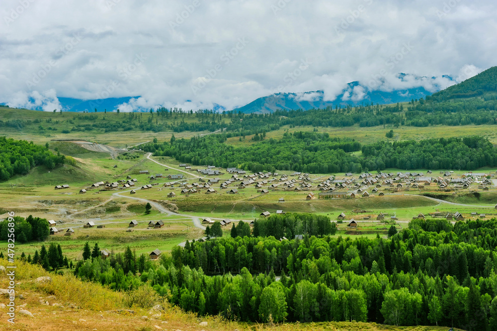 Mountains and forests surround the natural scenery of Hemu village in Kanas, Xinjiang, China - obrazy, fototapety, plakaty 