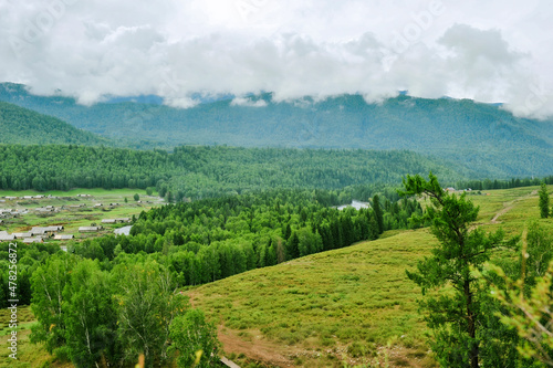 Mountains and forests surround the natural scenery of Hemu village in Kanas  Xinjiang  China