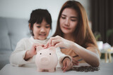 Family Savings. Mother Teaching Little Daughter How To Save Money Holding Piggybank