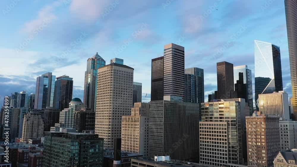 Rising aerial of Seattle's downtown skyscrapers with light fluffy clouds in the background. Rising aerial of Seattle's downtown skyscrapers with light fluffy clouds in the background.