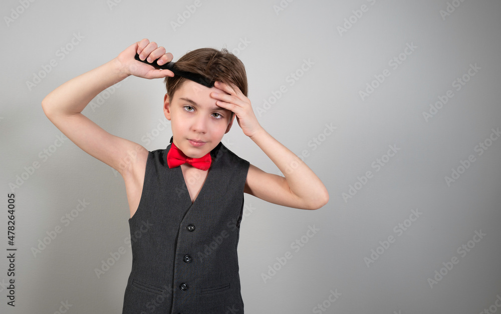 Cute boy with shaving foam and razor playfully posing against the background of a gray wall. Cute boy with shaving foam and razor playfully posing against the background of a gray wall.