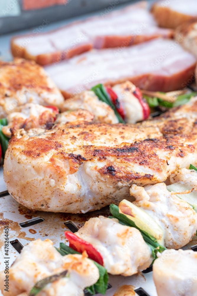 Chicken breast and pork meat pulled in wooden skewer with fresh colorful and tasty vegetables Chicken breast and pork meat pulled in wooden skewer with fresh colorful and tasty vegetables