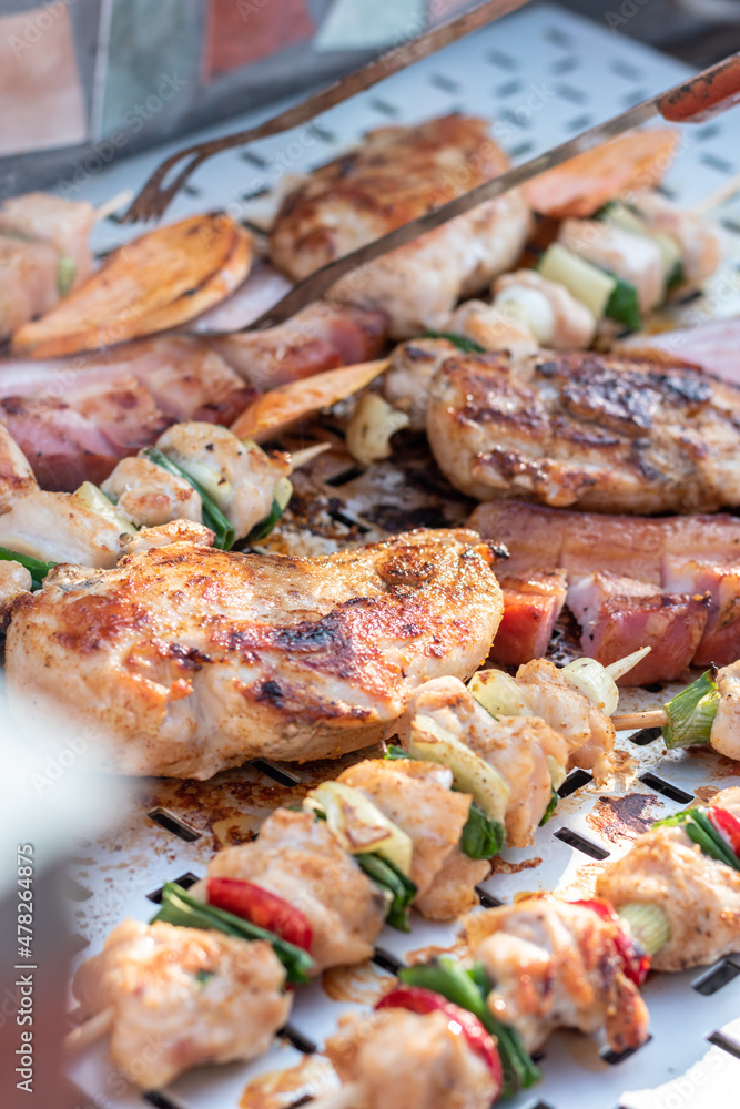Chicken breast and pork meat pulled in wooden skewer with fresh colorful and tasty vegetables